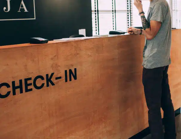 man standing in front of check in desk
