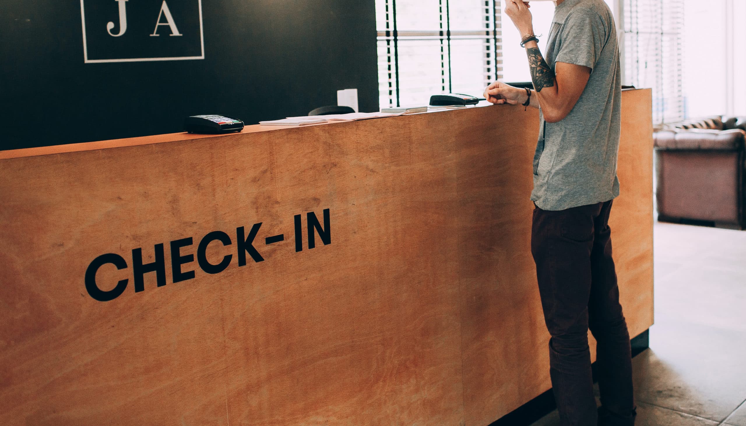 man standing in front of check in desk